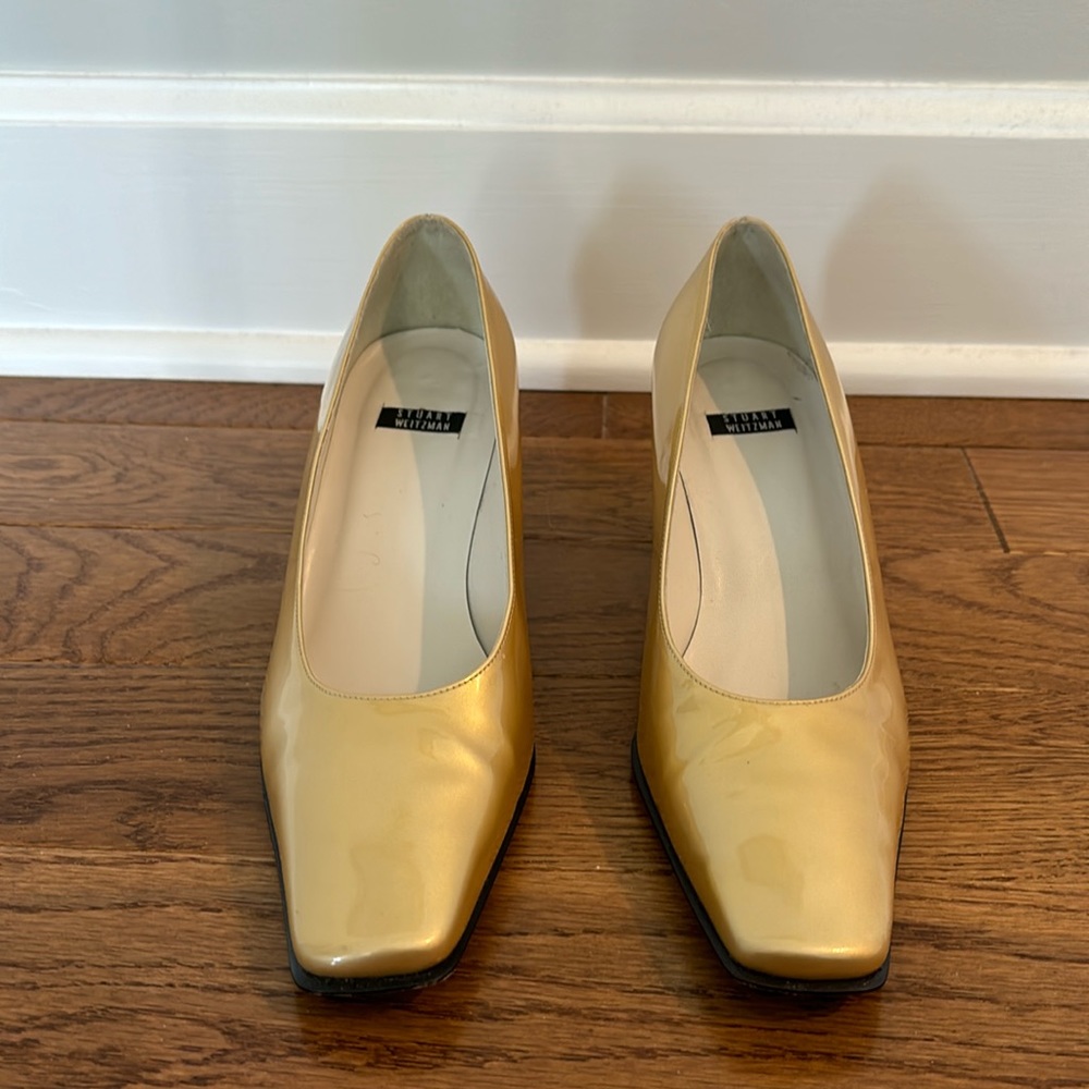 Stuart Weitzman gold leather pumps.